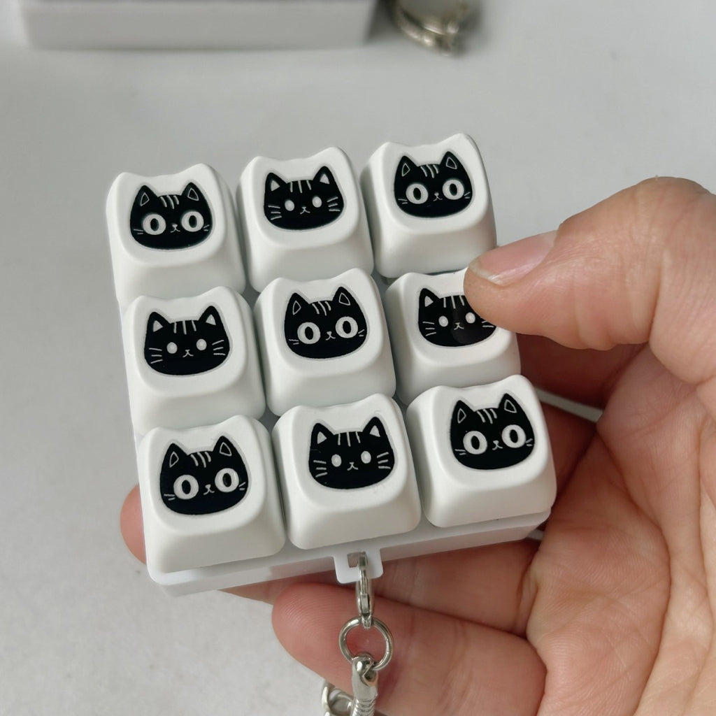 Black Cat Face keycap clicker keychain, 9-Key Black Cat held in hand
