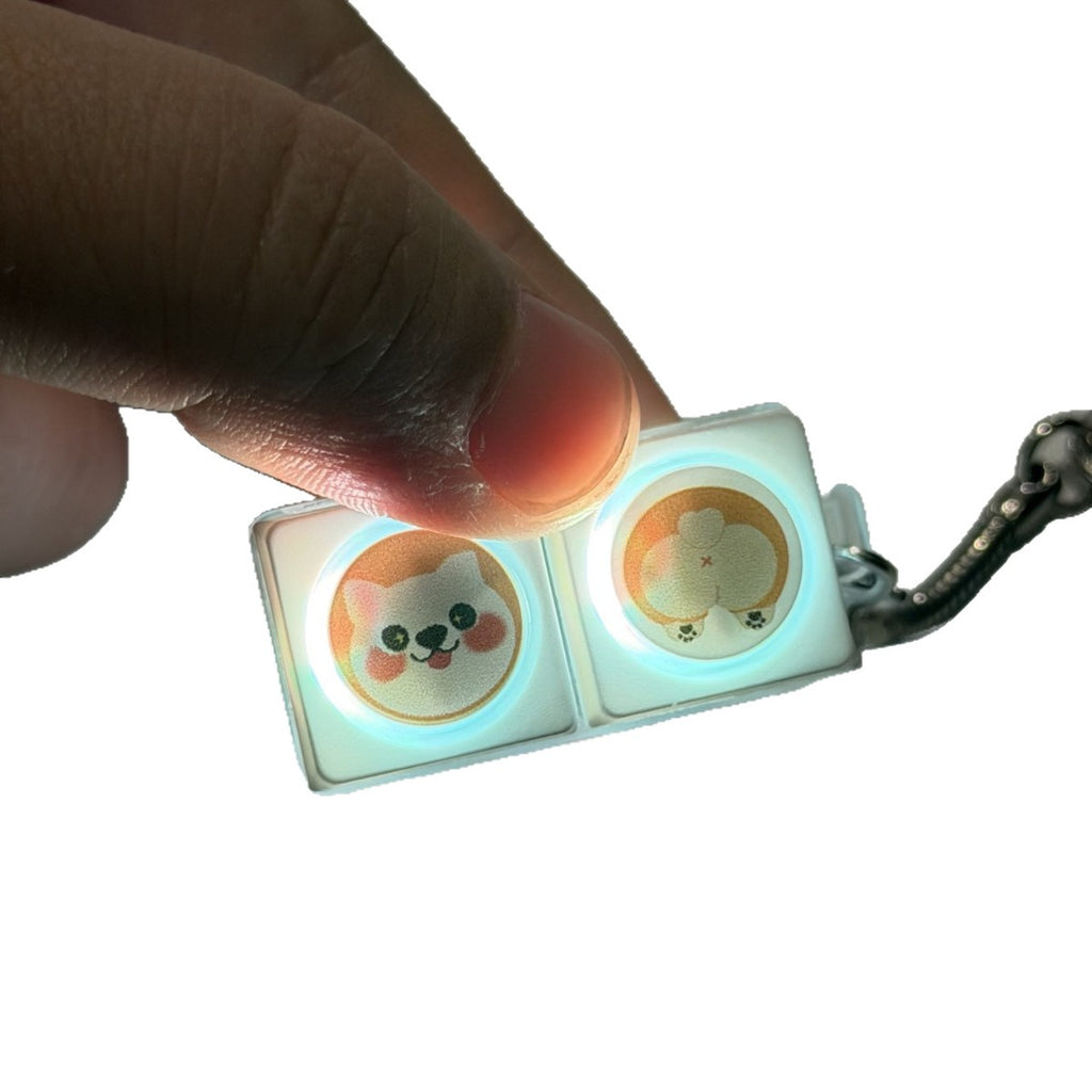 Finger pressing a corgi 2-key keycap clicker keychain