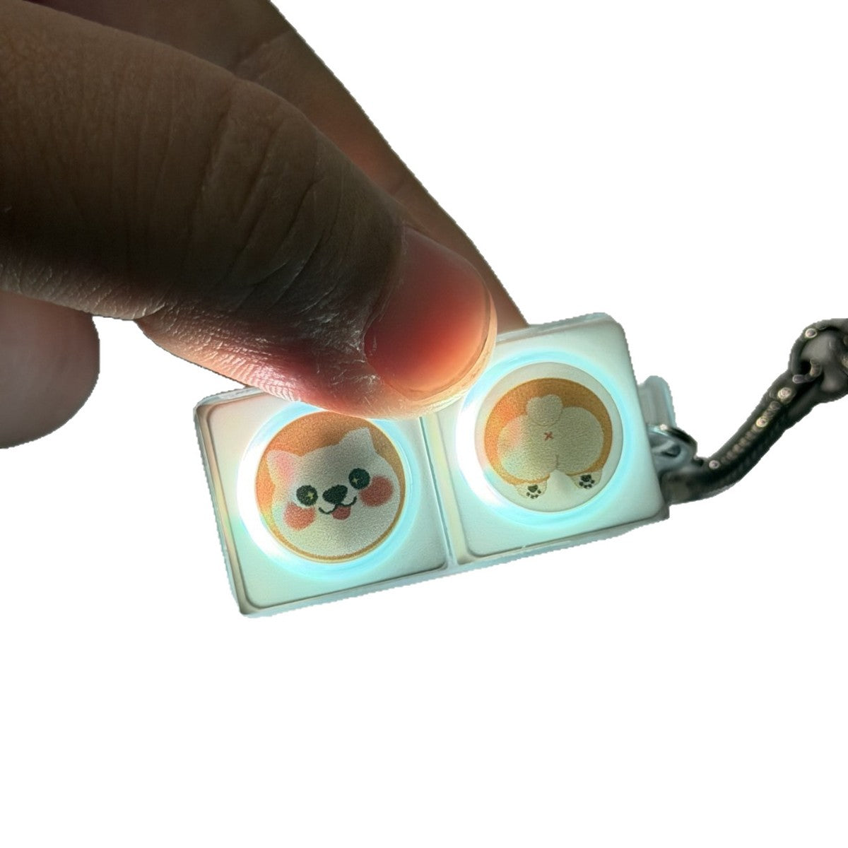Finger pressing a corgi 2-key keycap clicker keychain