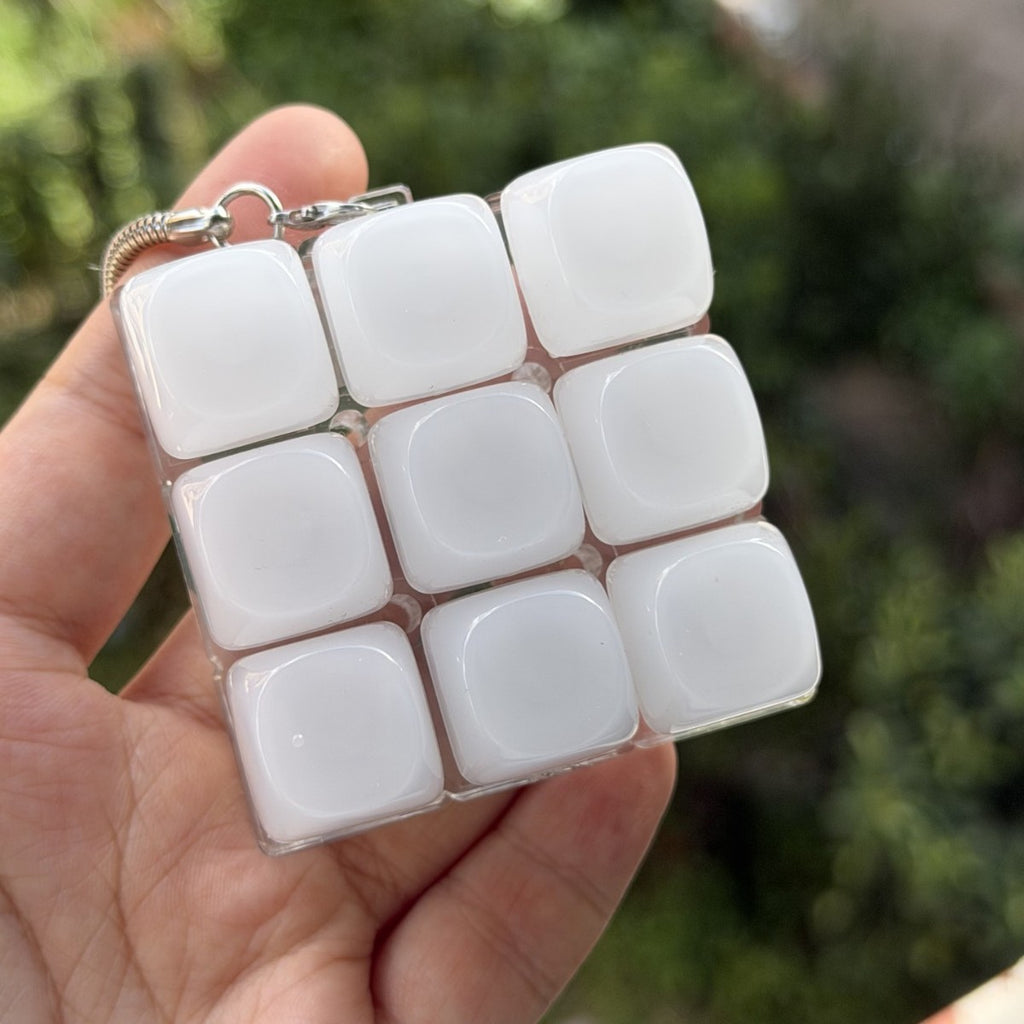 Hand holding a frosted jade-look 9-key keycap clicker