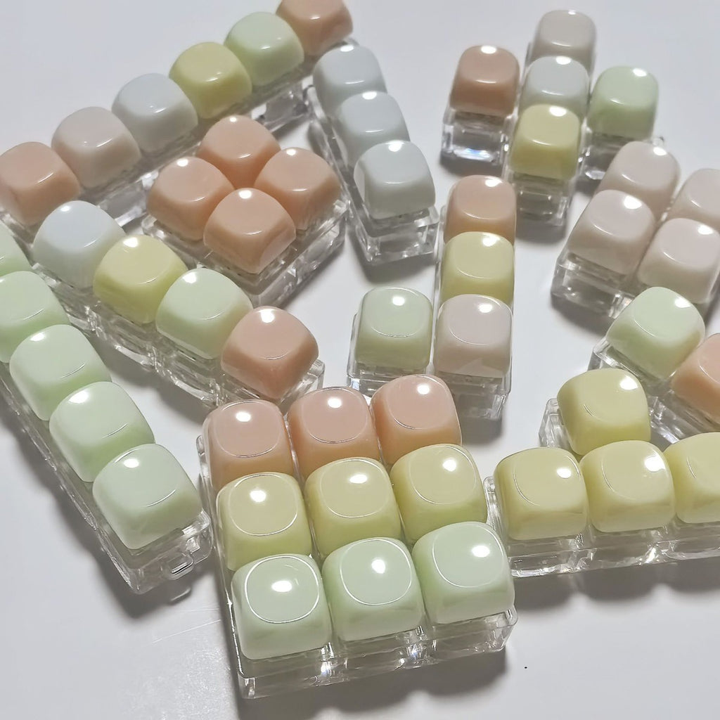 Rounded gummy keycap clicker keychains in pastel colours on clear bases