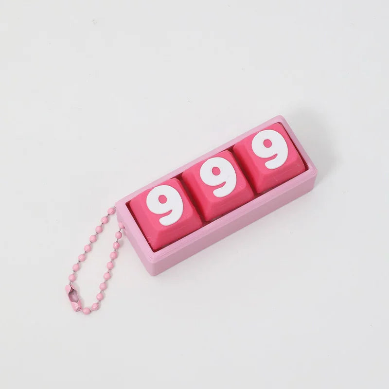 Matching pink 999 keycap clicker keychain design on a light grey background