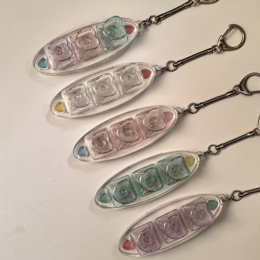 Clear leaf-shaped 3-key keycap clicker keychains in pink, mint, purple and clear