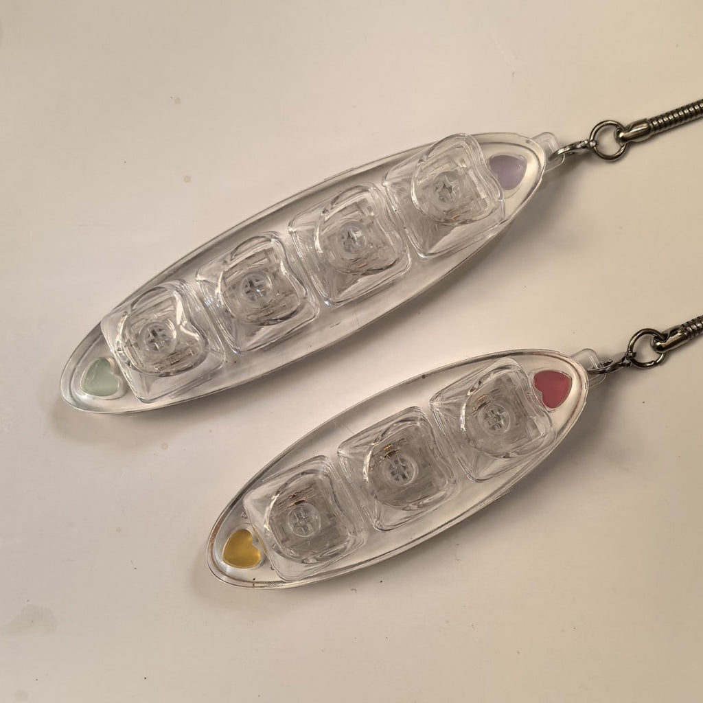 Two clear leaf-shaped 3-key keycap clicker keychains