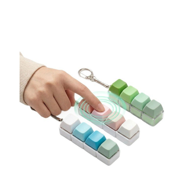 Hand pressing a macaron white-base 4-key keycap clicker keychain