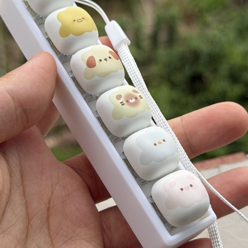 Close-up of a 6-key marshmallow animal keycap clicker with a strap