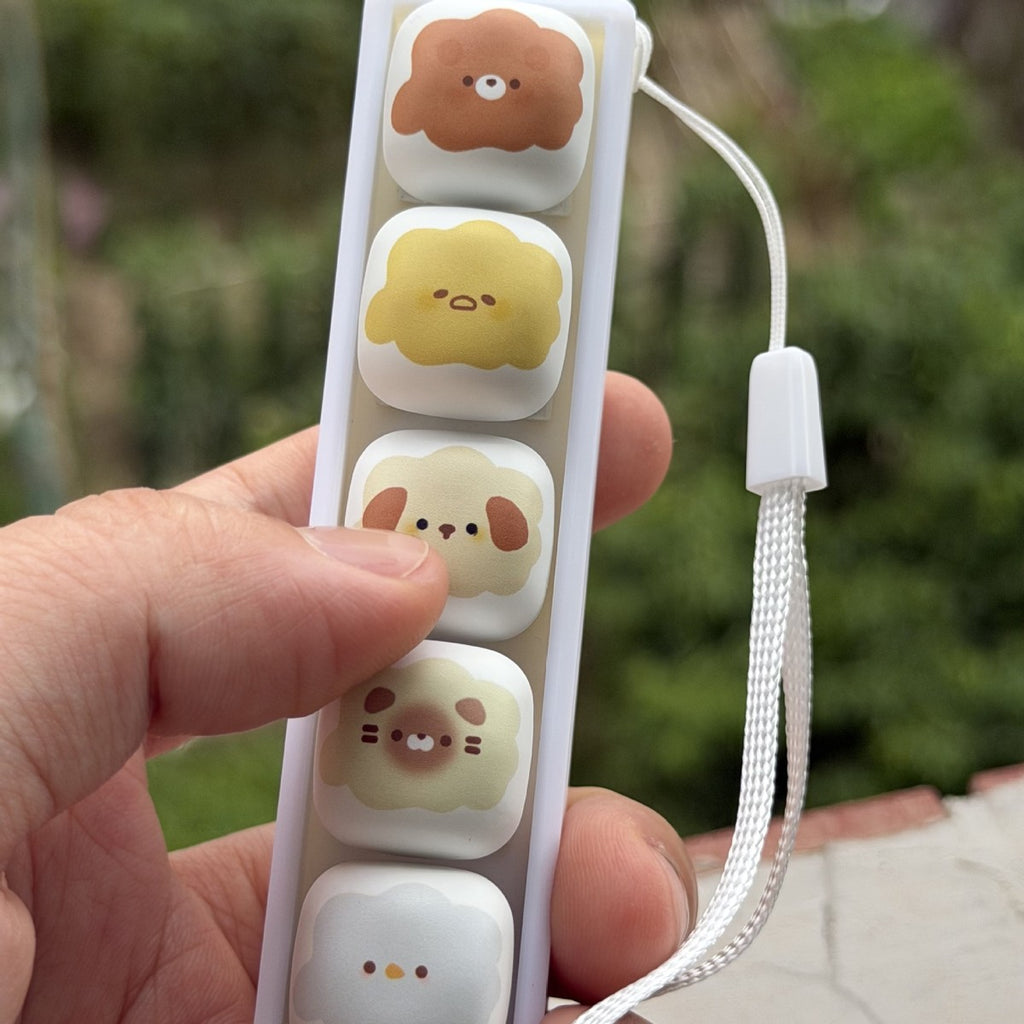 Hand holding a marshmallow animal 6-key keycap clicker
