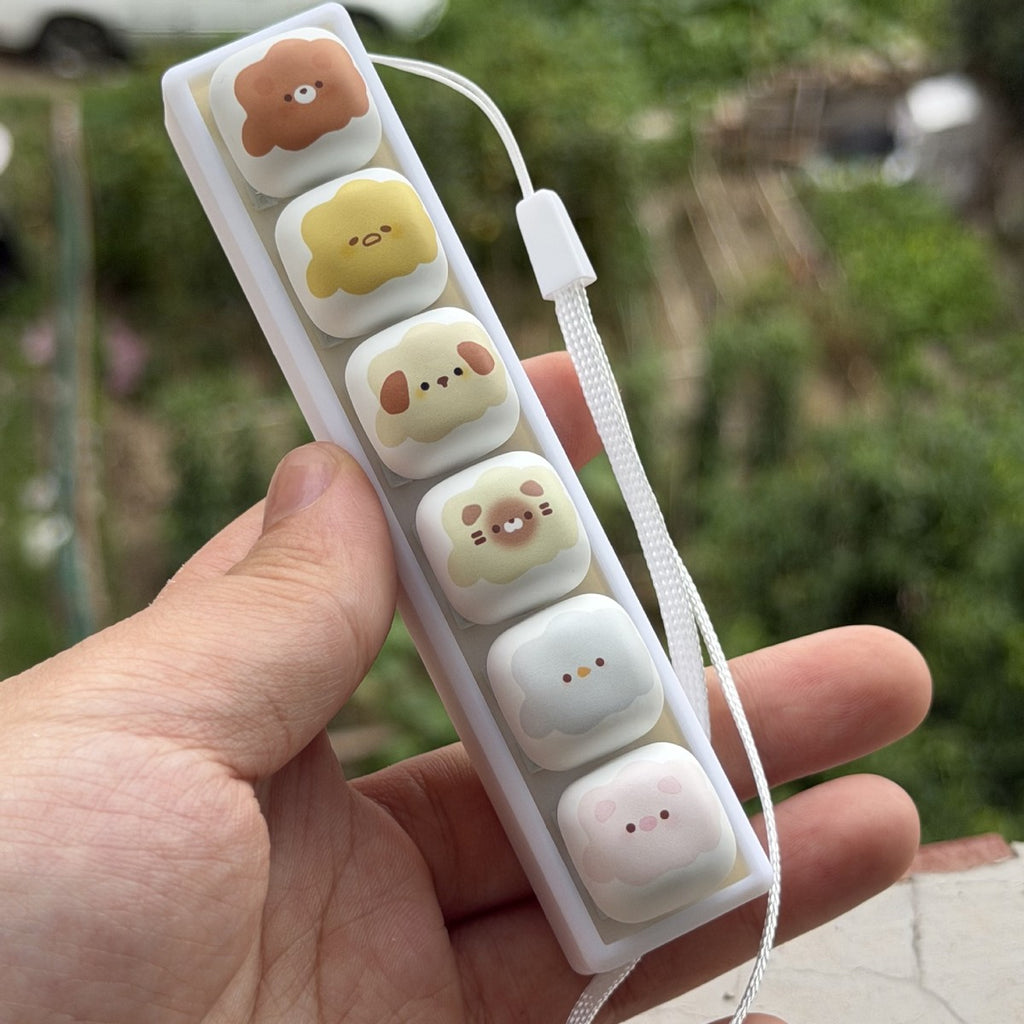 Marshmallow animal 6-key keycap clicker held at an angle