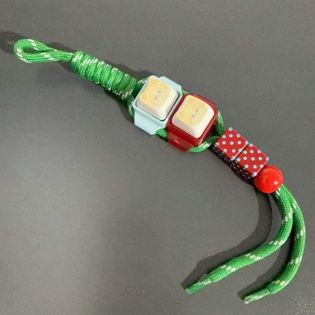 Modular keycap clicker keychain with a green and red cord
