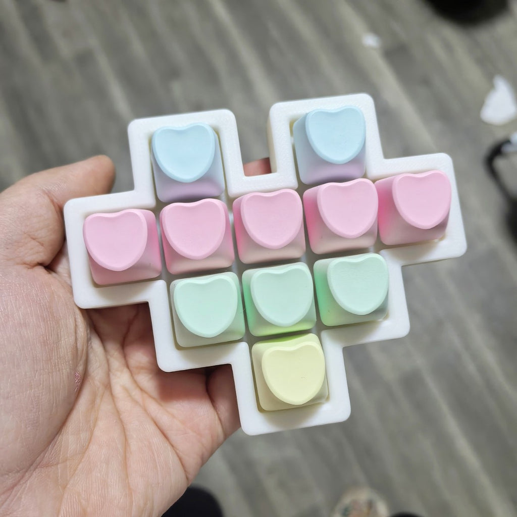 Hand holding a pastel heart 11-key keycap clicker