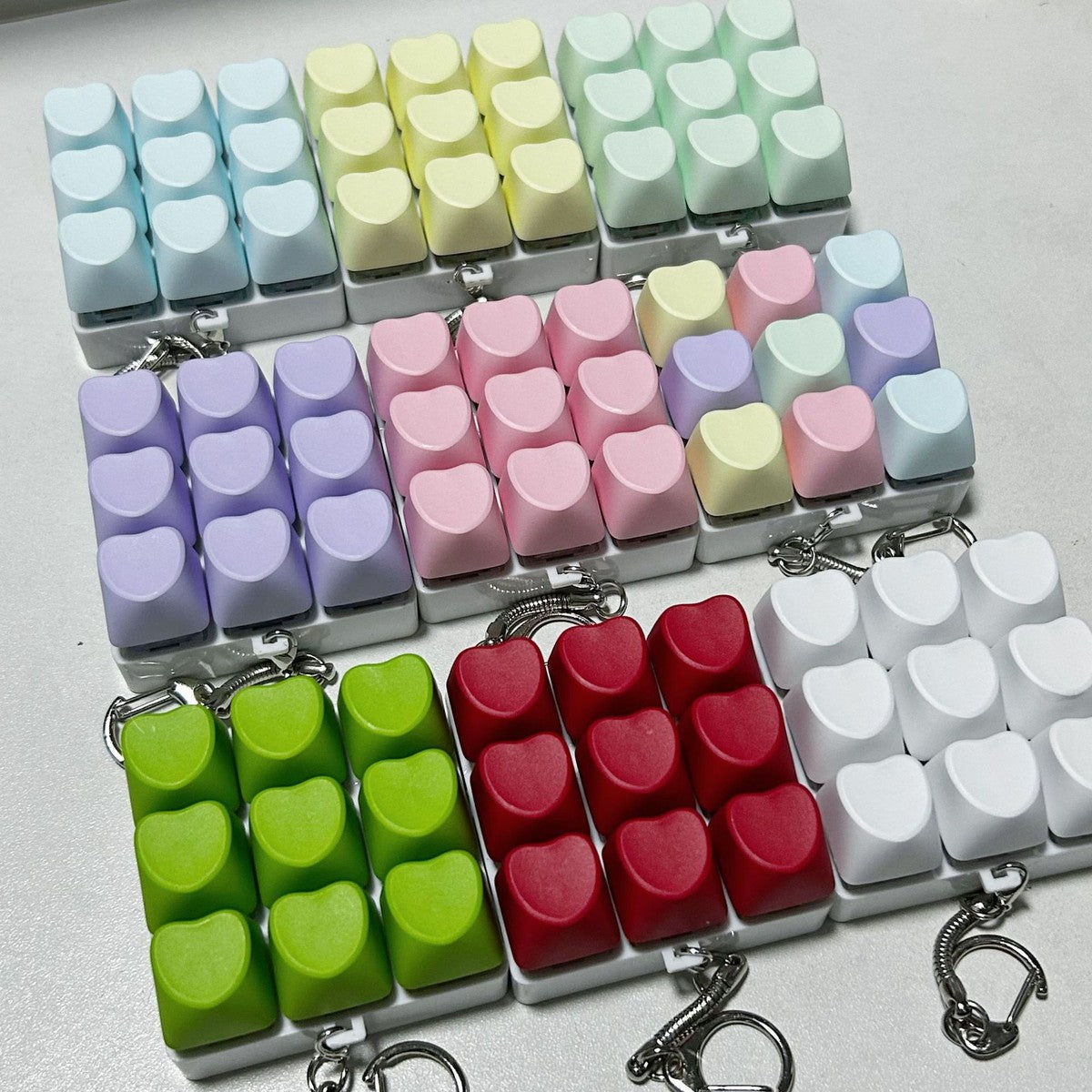 Pastel heart 9-key keycap clicker keychains in white, blue, yellow, green, purple, pink and red