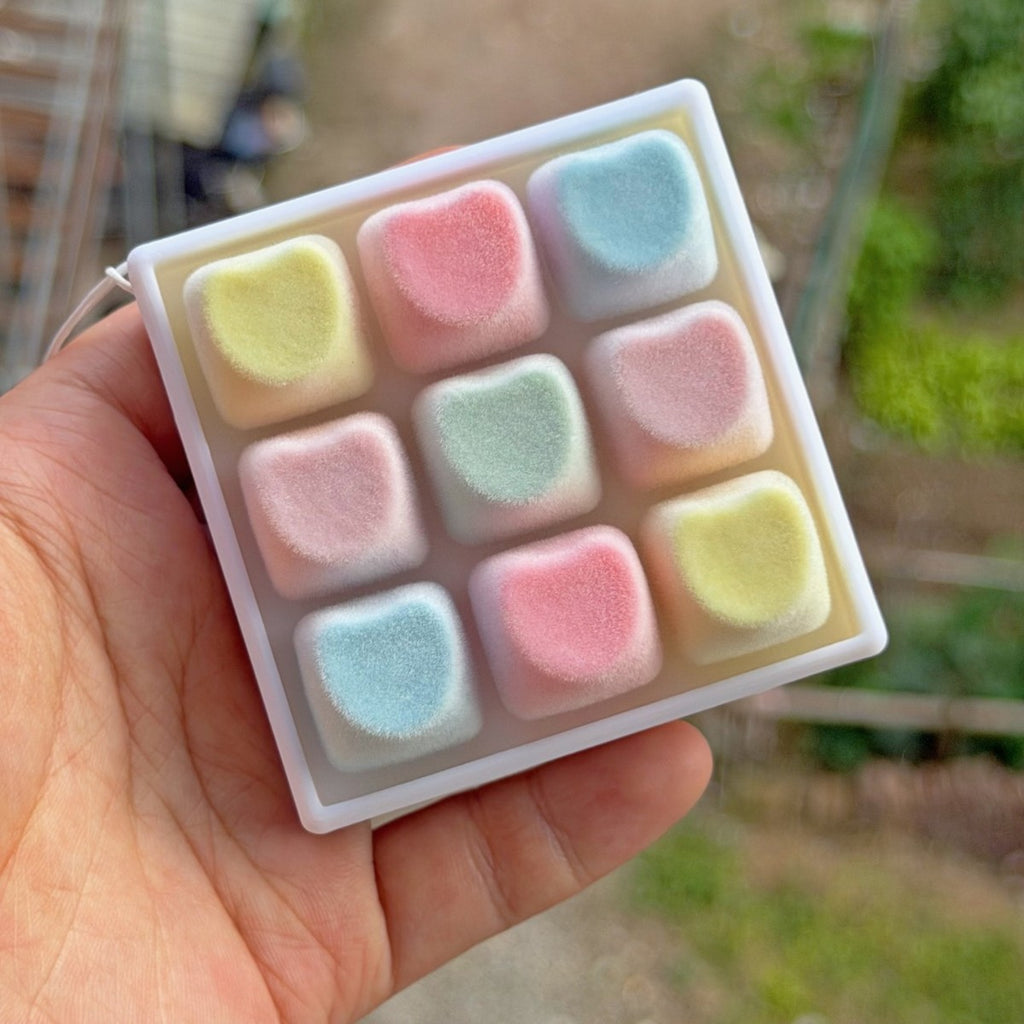 Hand holding a plush-style pastel 9-key keycap clicker