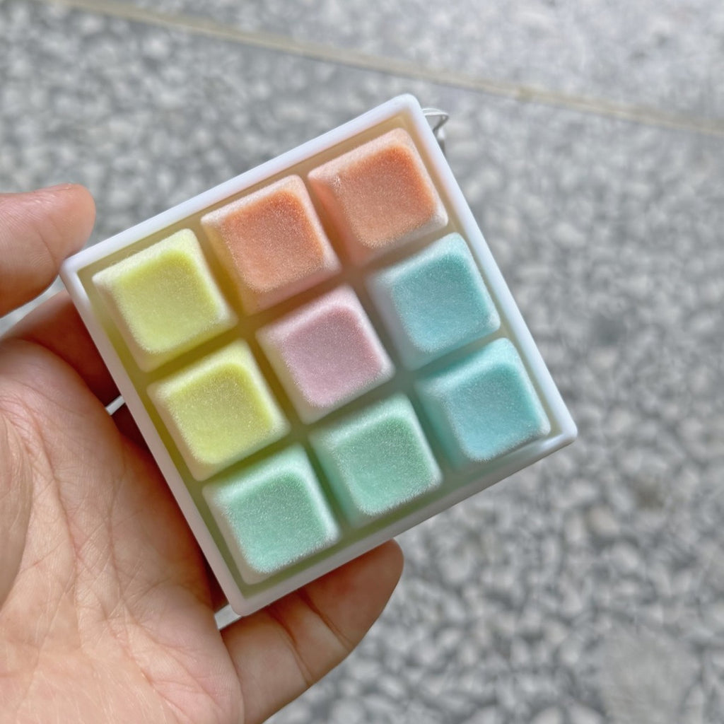 Pastel plush-style 9-key keycap clicker with orange, yellow and mint keys