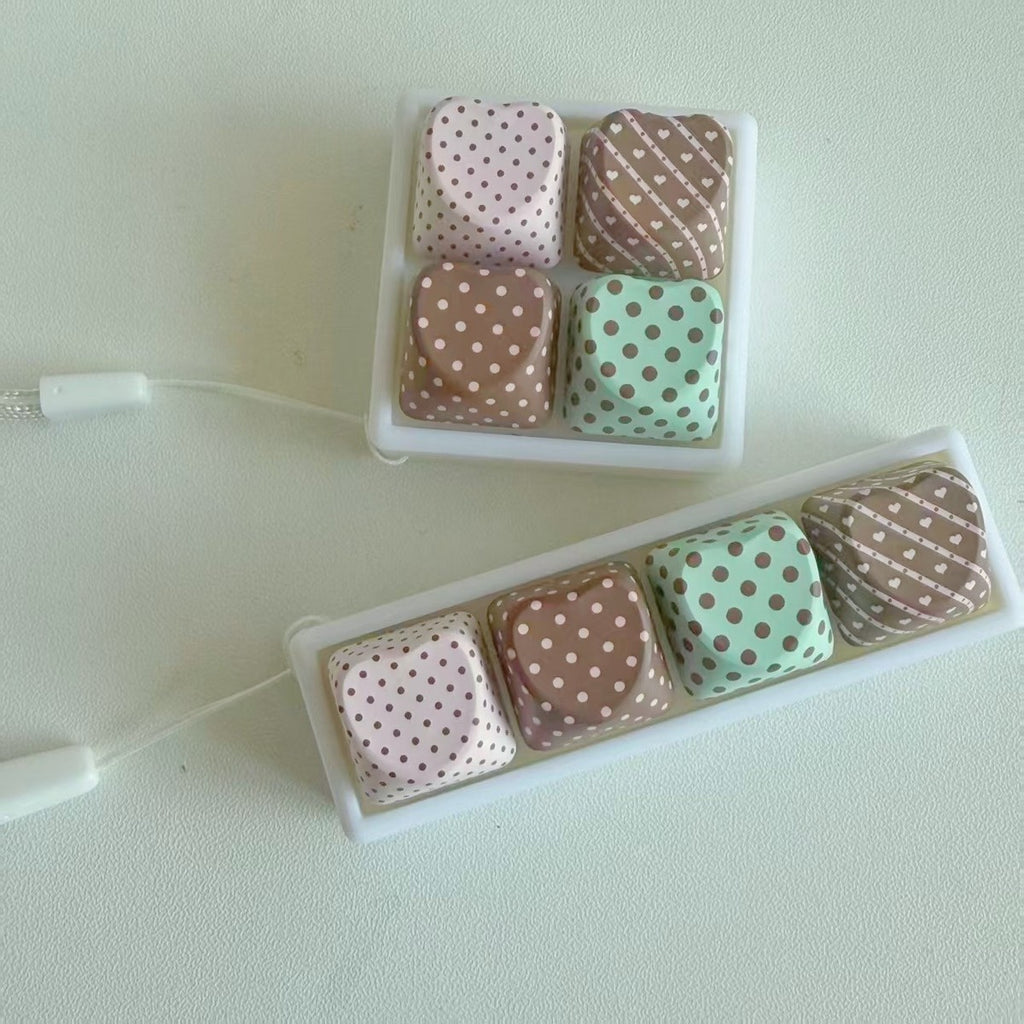 Polka-dot keycap clicker keychains, one 2x2 grid and one in-line 4-key