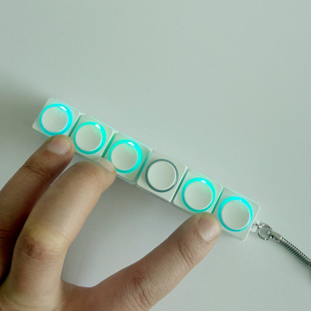 In-line white round-button clicker keychain with glowing rings