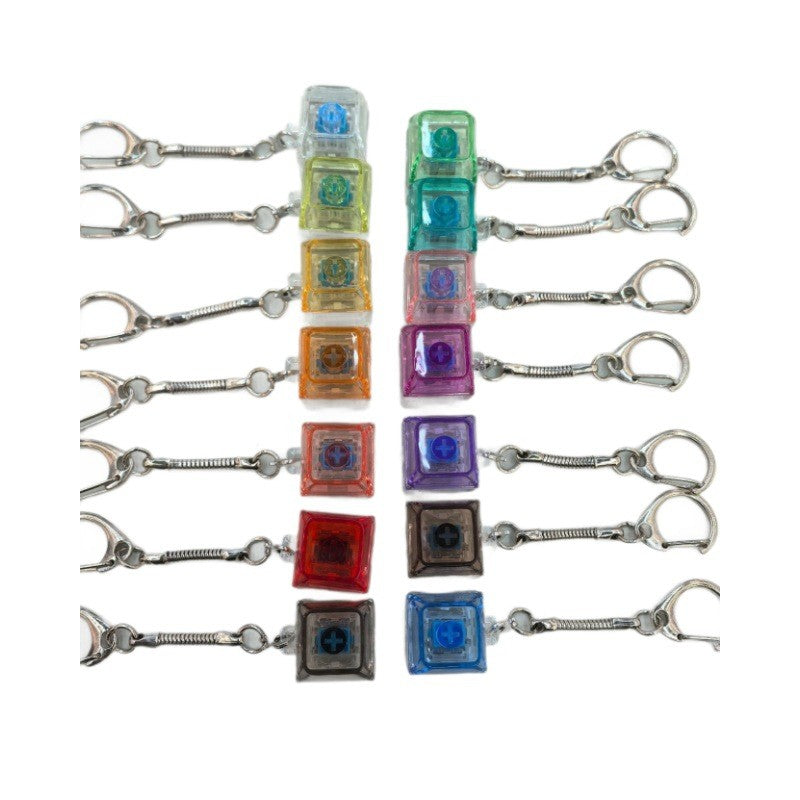 Single-key keycap clicker keychains in a row of translucent colours
