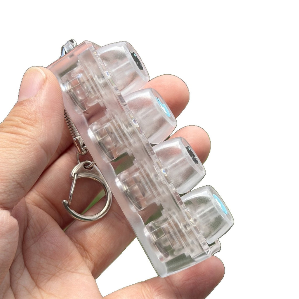 Frosted white 4-key keycap clicker keychain held at an angle